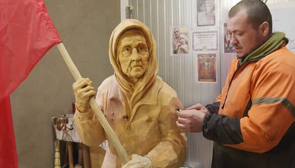 The sculptor is working on the figure of 'Grandmother with a Flag''