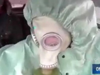 Taxi driver in chemical protection suit